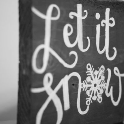 Let it Snow painted lettering on a 12 x 12 wood board