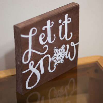 Let it Snow painted lettering on a 12 x 12 wood board