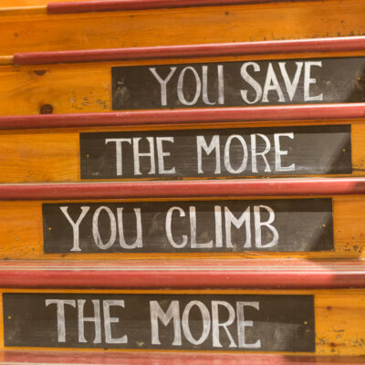 "The more you climb, the more you save" stairway featuring the bargain section of the Vermont Country Store.
